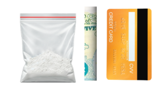 bag of cocaine, rolled up banknote, bank card